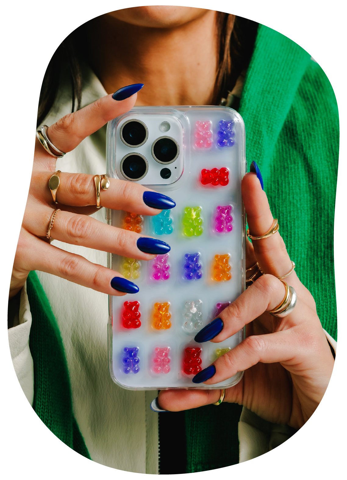 Person holding a phone with a colorful gummy bear case