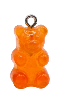 Orange gummy bear charm with a metal ring on a white background